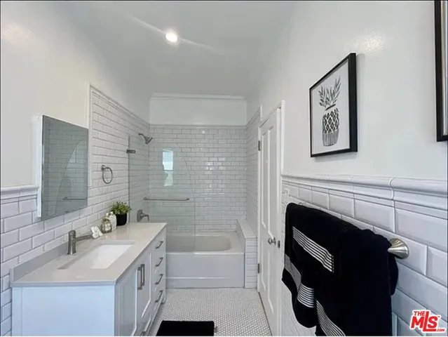 a bathroom with a double vanity sink toilet and a mirror