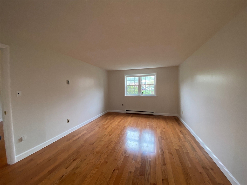 8 Old Colony Lane, Unit 2 Arlington, MA 02476 - Photo 3 of 12 a view of a room with wooden floor and window