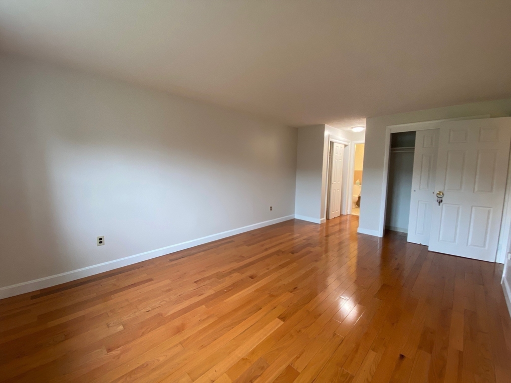 8 Old Colony Lane, Unit 2 Arlington, MA 02476 - Photo 4 of 12 a view of empty room with wooden floor