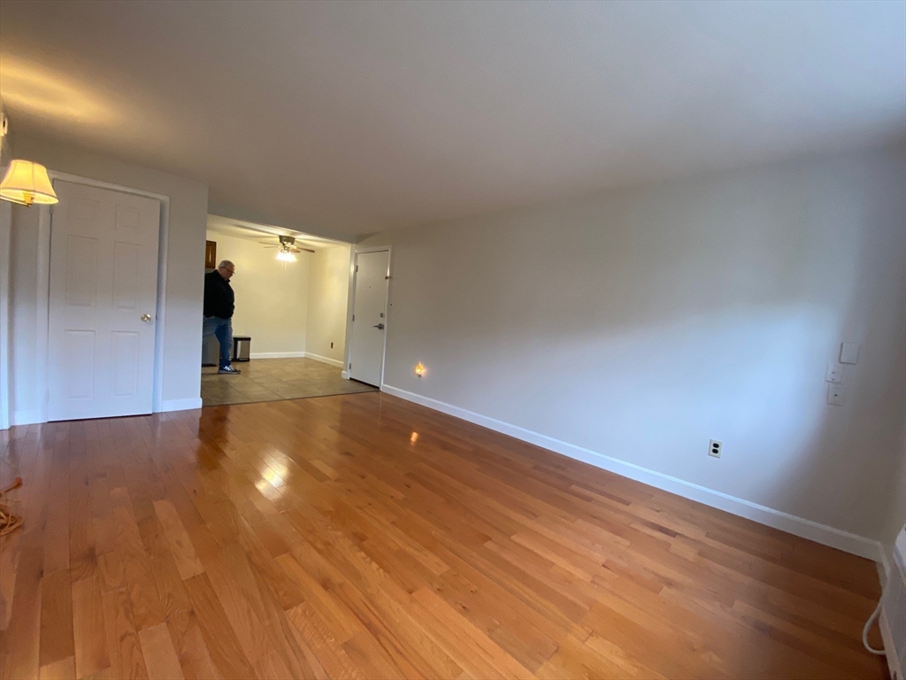 8 Old Colony Lane, Unit 2 Arlington, MA 02476 - Photo 7 of 12 a view of an empty room and wooden floor