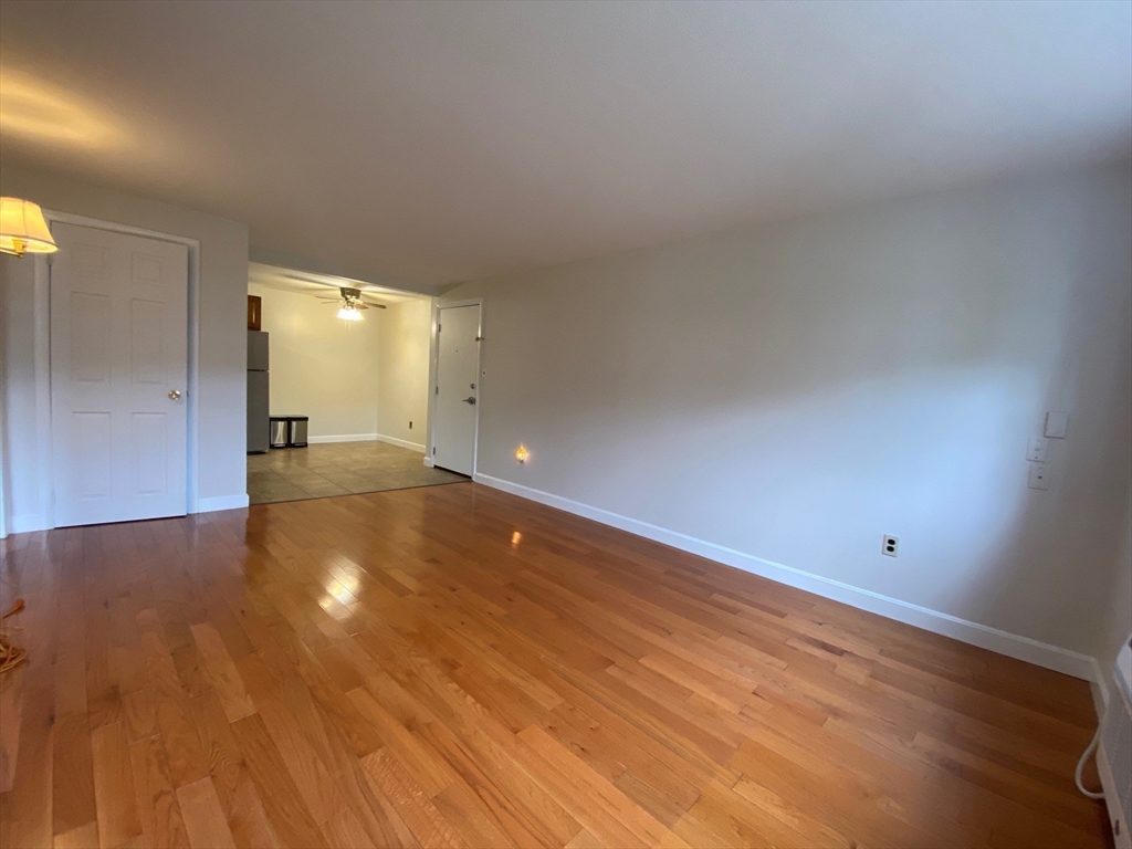 8 Old Colony Lane, Unit 2 Arlington, MA 02476 - Photo 8 of 12 a view of an empty room and wooden floor