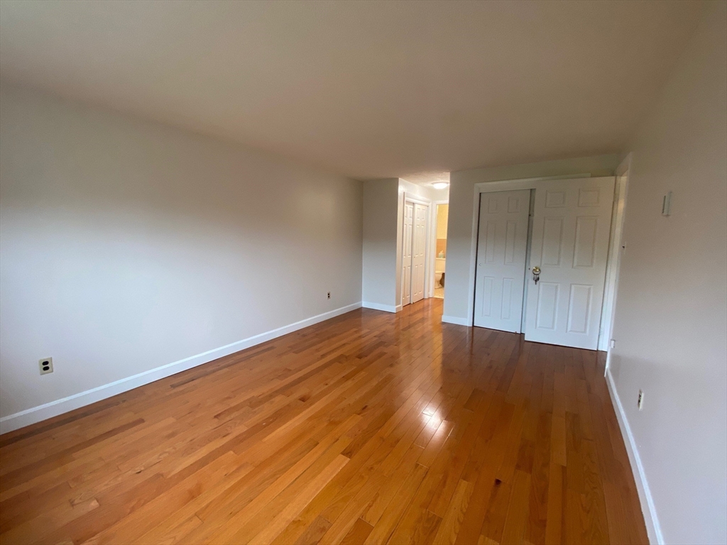 8 Old Colony Lane, Unit 2 Arlington, MA 02476 - Photo 9 of 12 a view of empty room with wooden floor