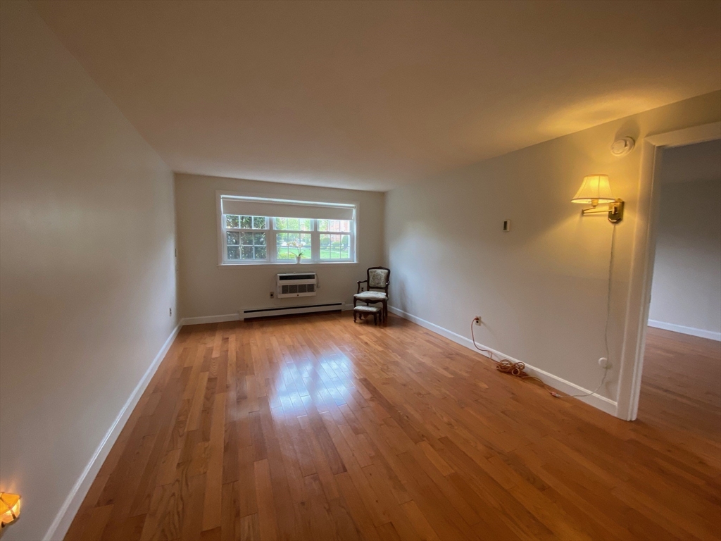 8 Old Colony Lane, Unit 2 Arlington, MA 02476 - Photo 10 of 12 an empty room with wooden floor and windows
