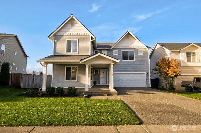 a front view of a house with a yard and garage