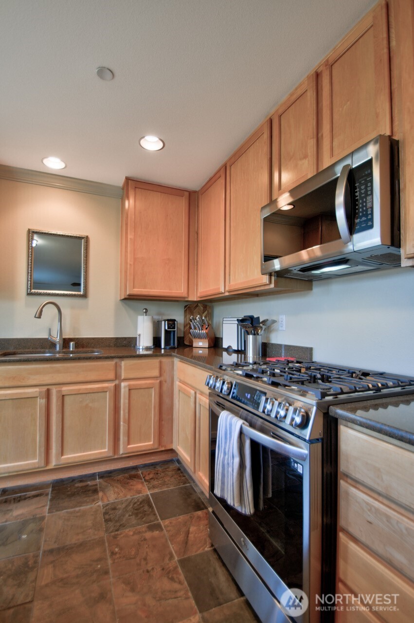 3172 Sheaser Way DuPont, WA 98327 - Photo 13 of 34 a kitchen with stainless steel appliances granite countertop a stove top oven a sink and dishwasher