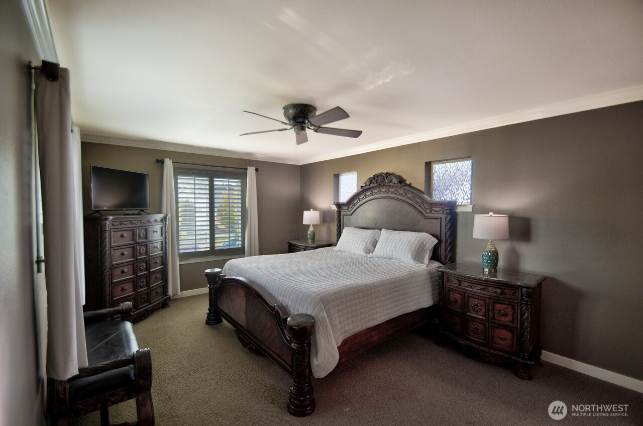 3172 Sheaser Way DuPont, WA 98327 - Photo 14 of 34 a spacious bedroom with a bed and a chandelier
