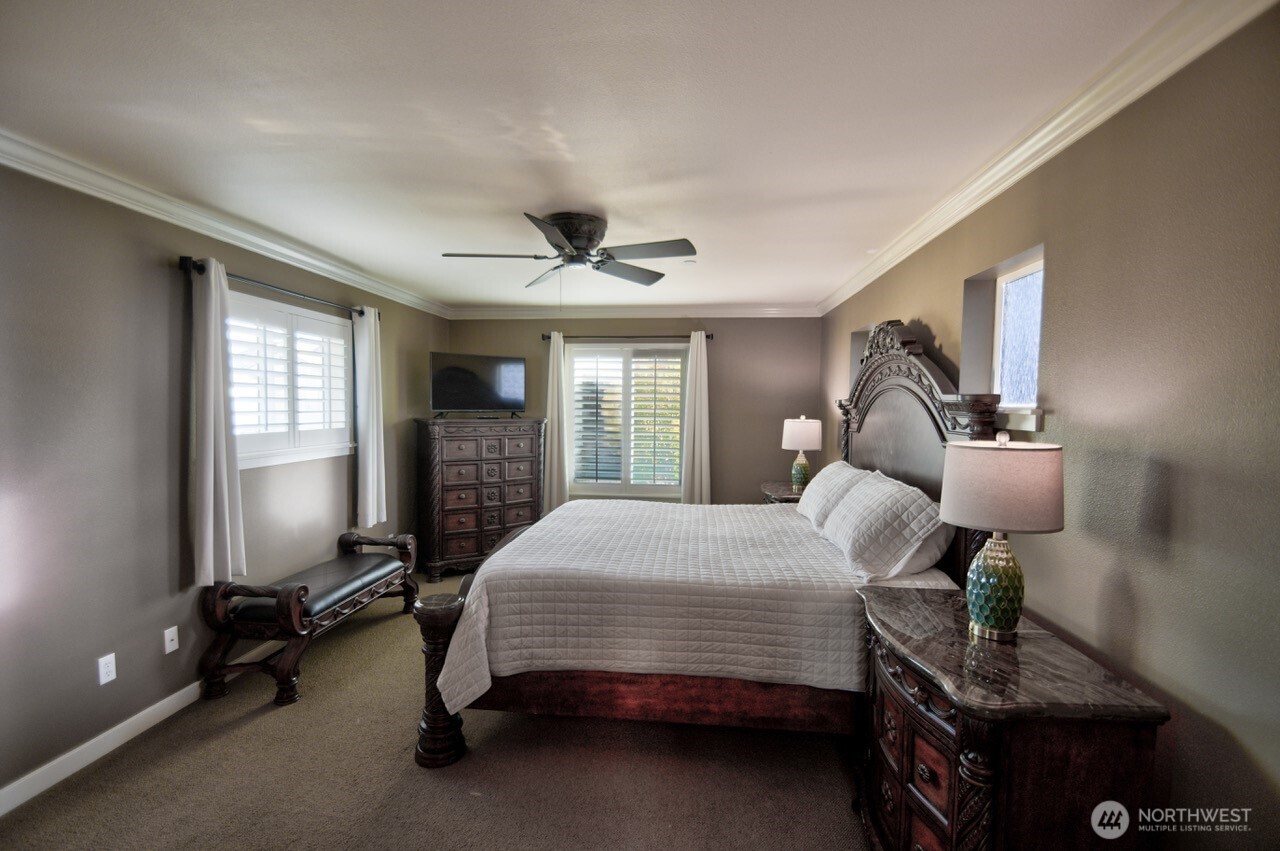 3172 Sheaser Way DuPont, WA 98327 - Photo 16 of 34 a bedroom with a bed and a chandelier