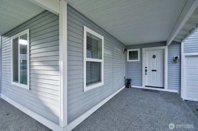 a view of empty room with a window and fireplace