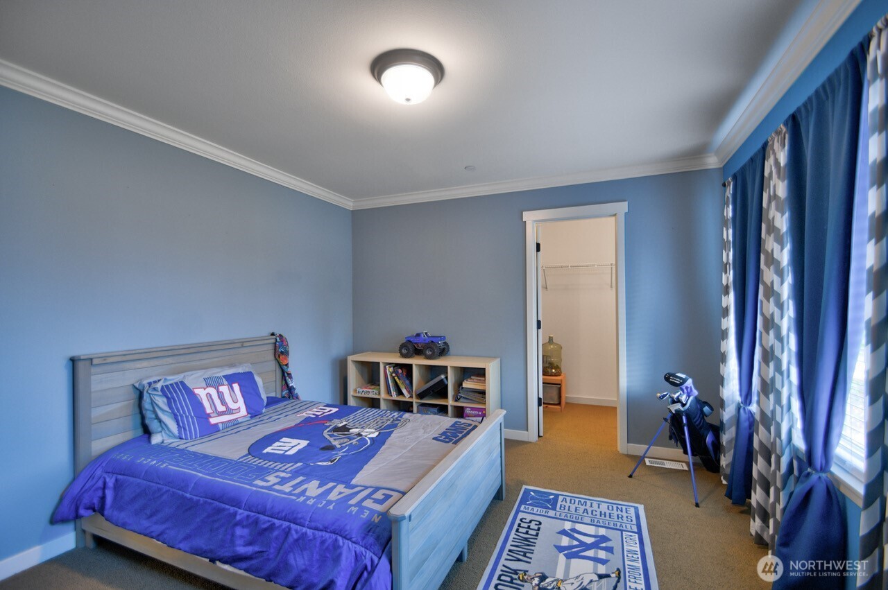 3172 Sheaser Way DuPont, WA 98327 - Photo 22 of 34 a bedroom with a bed and a chandelier