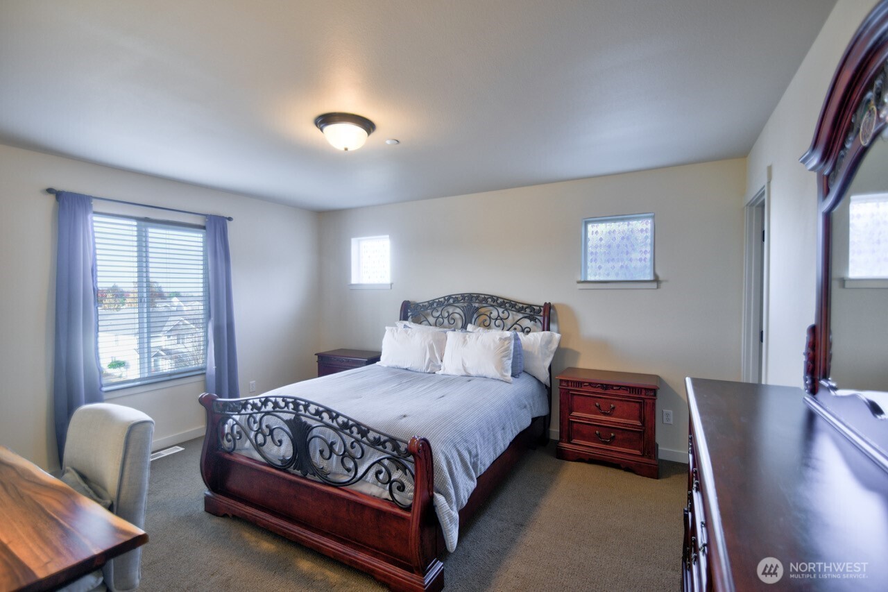 3172 Sheaser Way DuPont, WA 98327 - Photo 23 of 34 a bedroom with a bed window and couch
