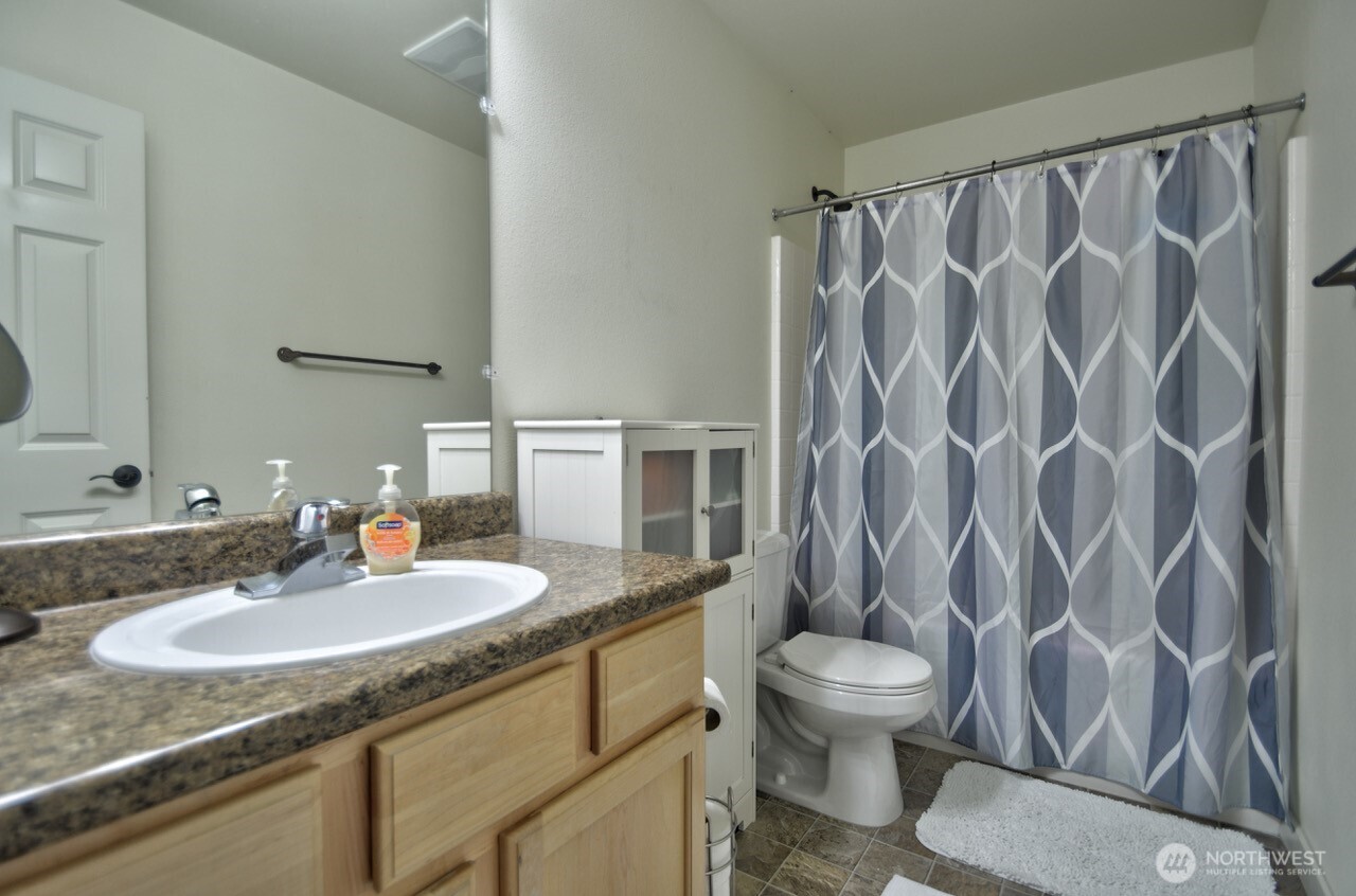 3172 Sheaser Way DuPont, WA 98327 - Photo 28 of 34 a bathroom with a granite countertop sink and a mirror