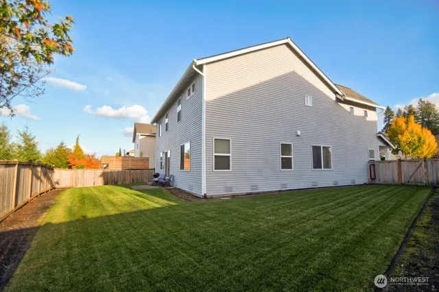 a backyard of a house with table and chairs
