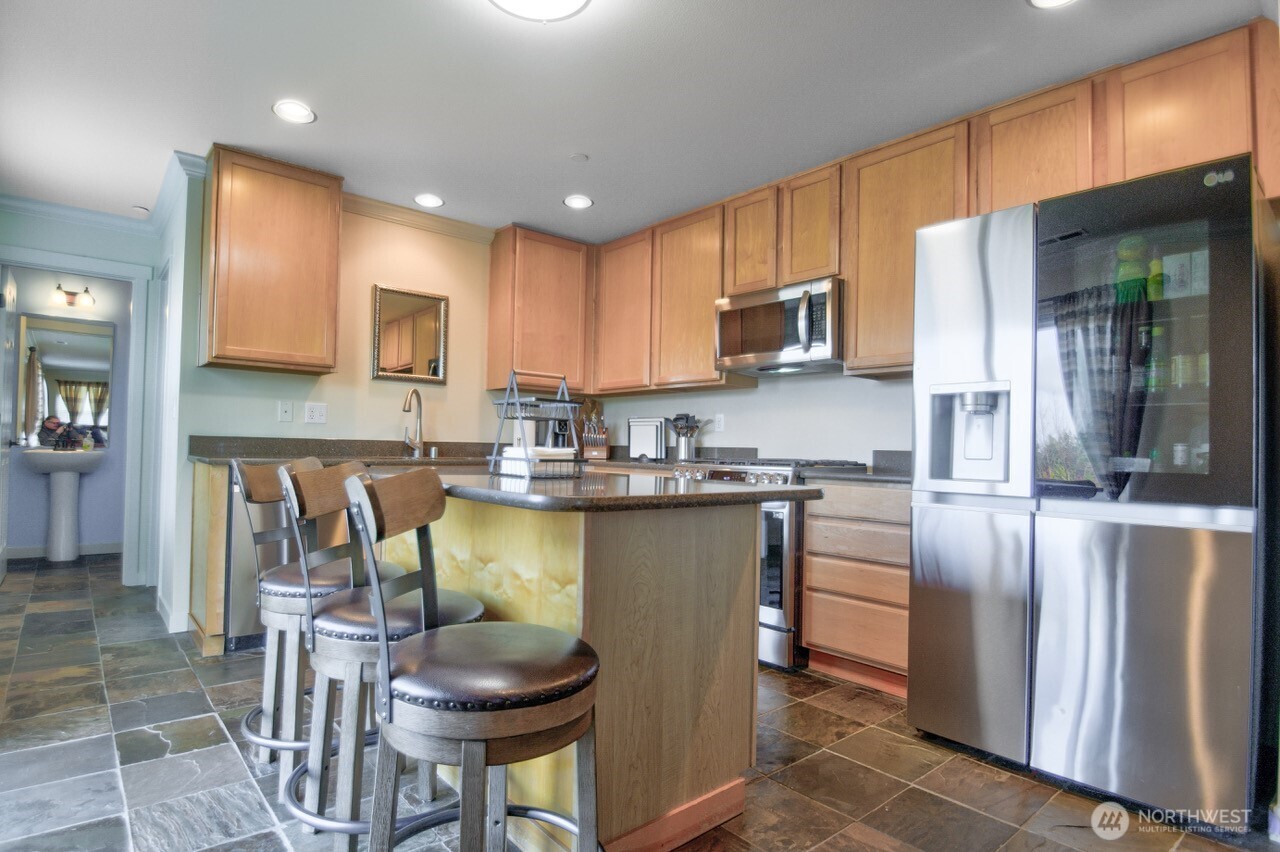 3172 Sheaser Way DuPont, WA 98327 - Photo 9 of 34 a kitchen with stainless steel appliances granite countertop a stove refrigerator sink and cabinets