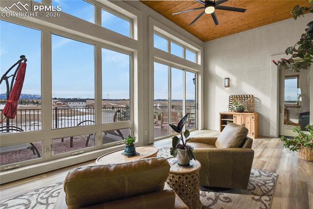 5220 Roundup Ridge Road Colorado Springs, CO 80908 - Photo 13 of 50 Enclosed sunroom with new LVP flooring and views!