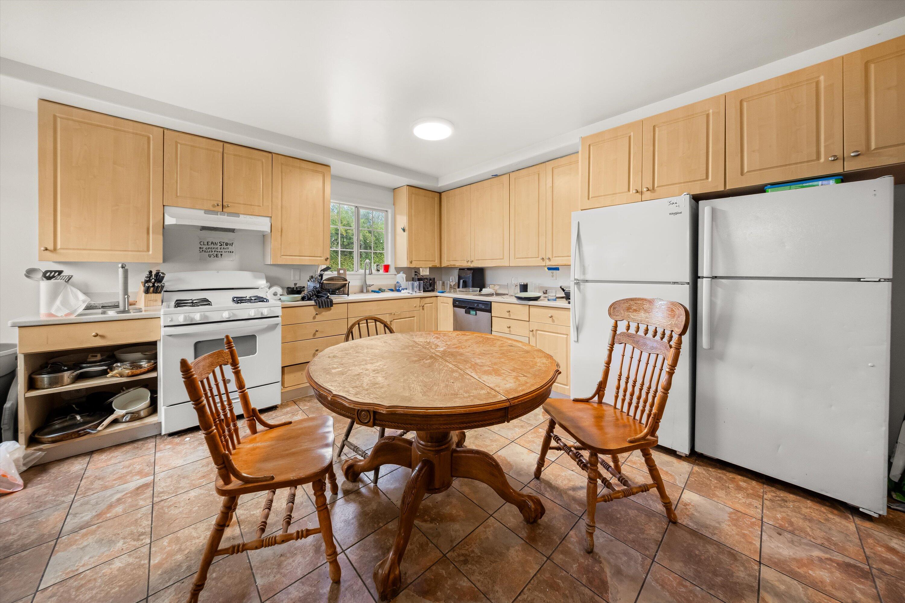 6670 Sueno Road Isla Vista, CA 93117 - Photo 13 of 20 a kitchen with stainless steel appliances a refrigerator a stove a dining table and chairs