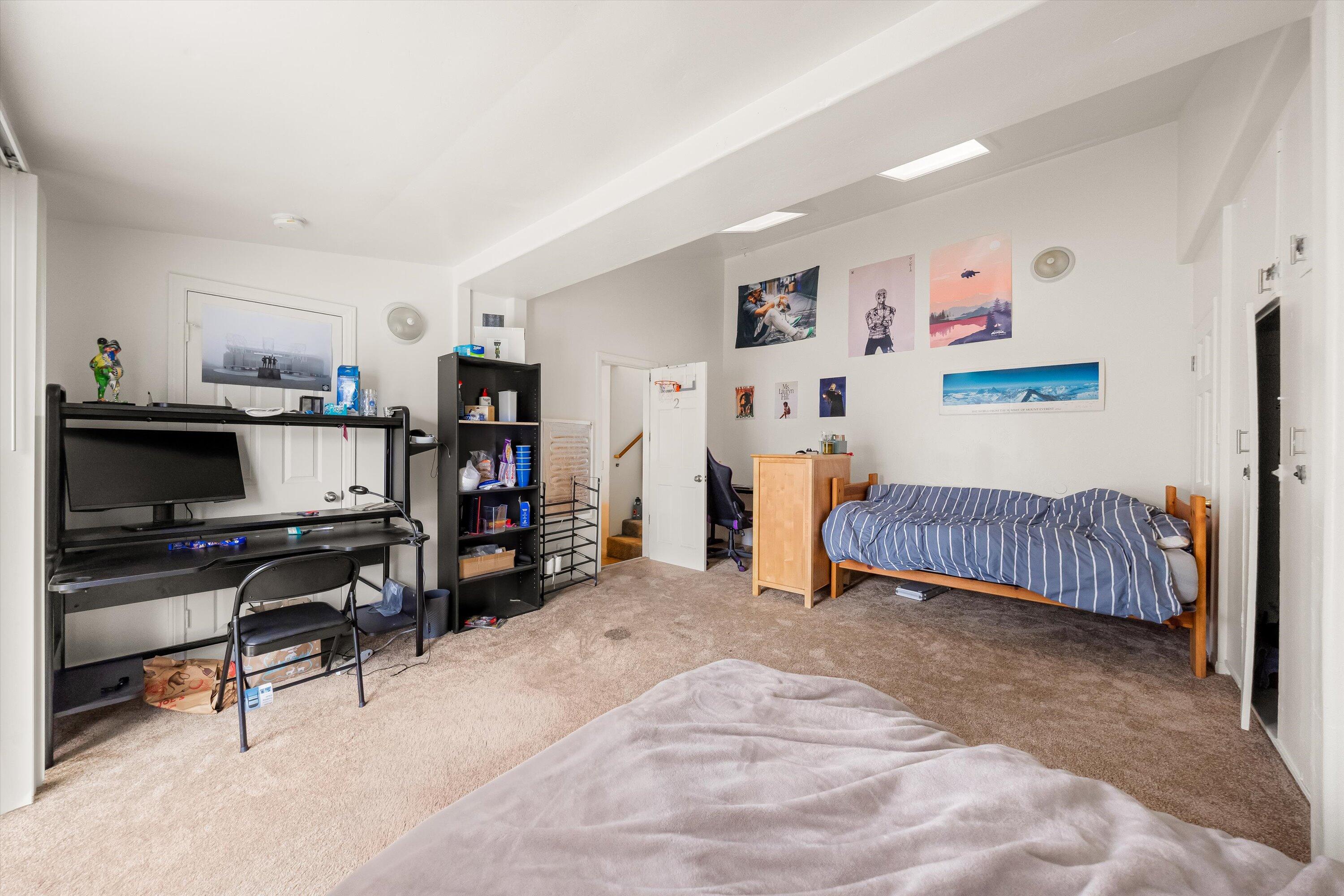6670 Sueno Road Isla Vista, CA 93117 - Photo 15 of 20 a bedroom with a bed a desk and chair