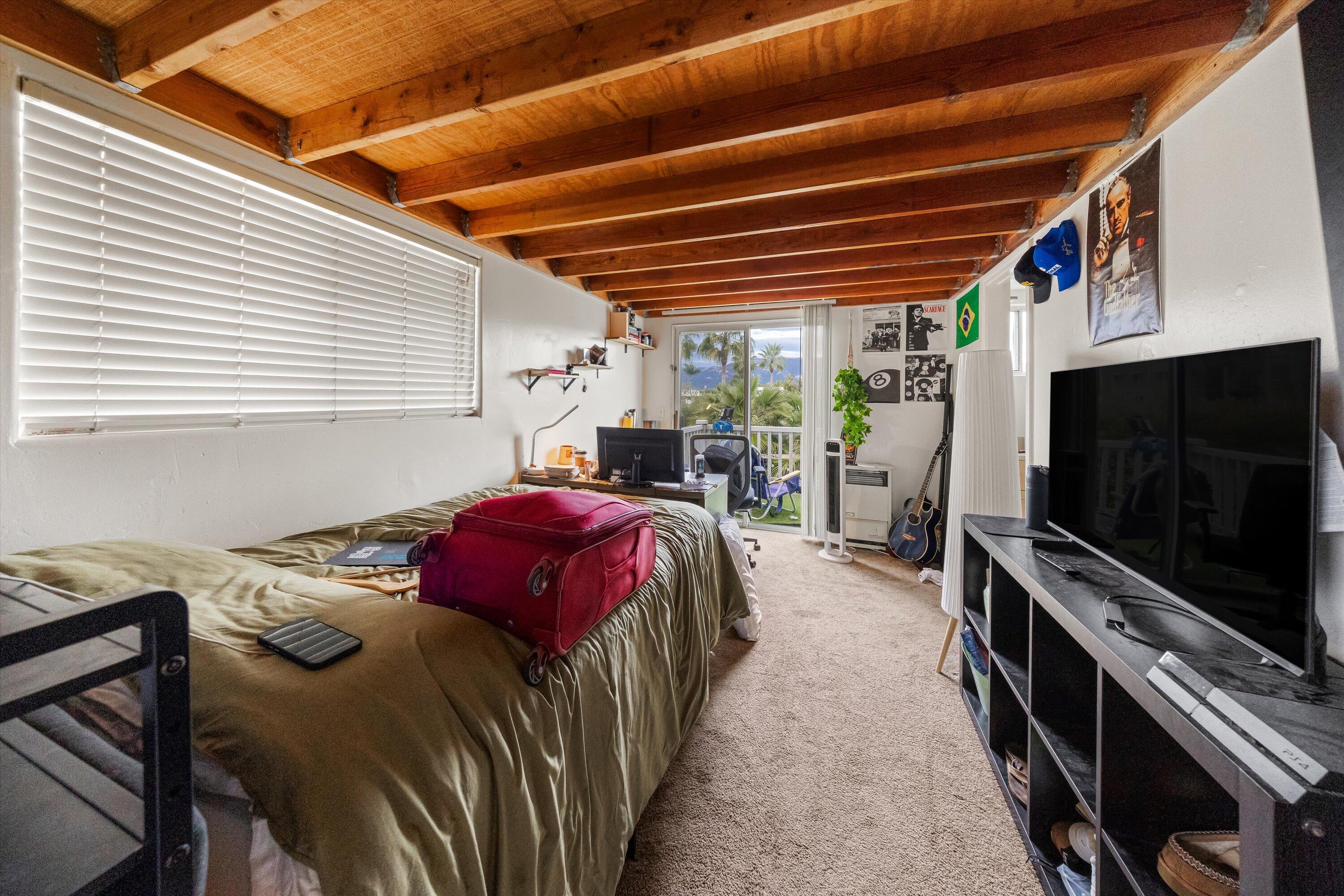6670 Sueno Road Isla Vista, CA 93117 - Photo 16 of 20 a bed sitting in a bedroom next to a window