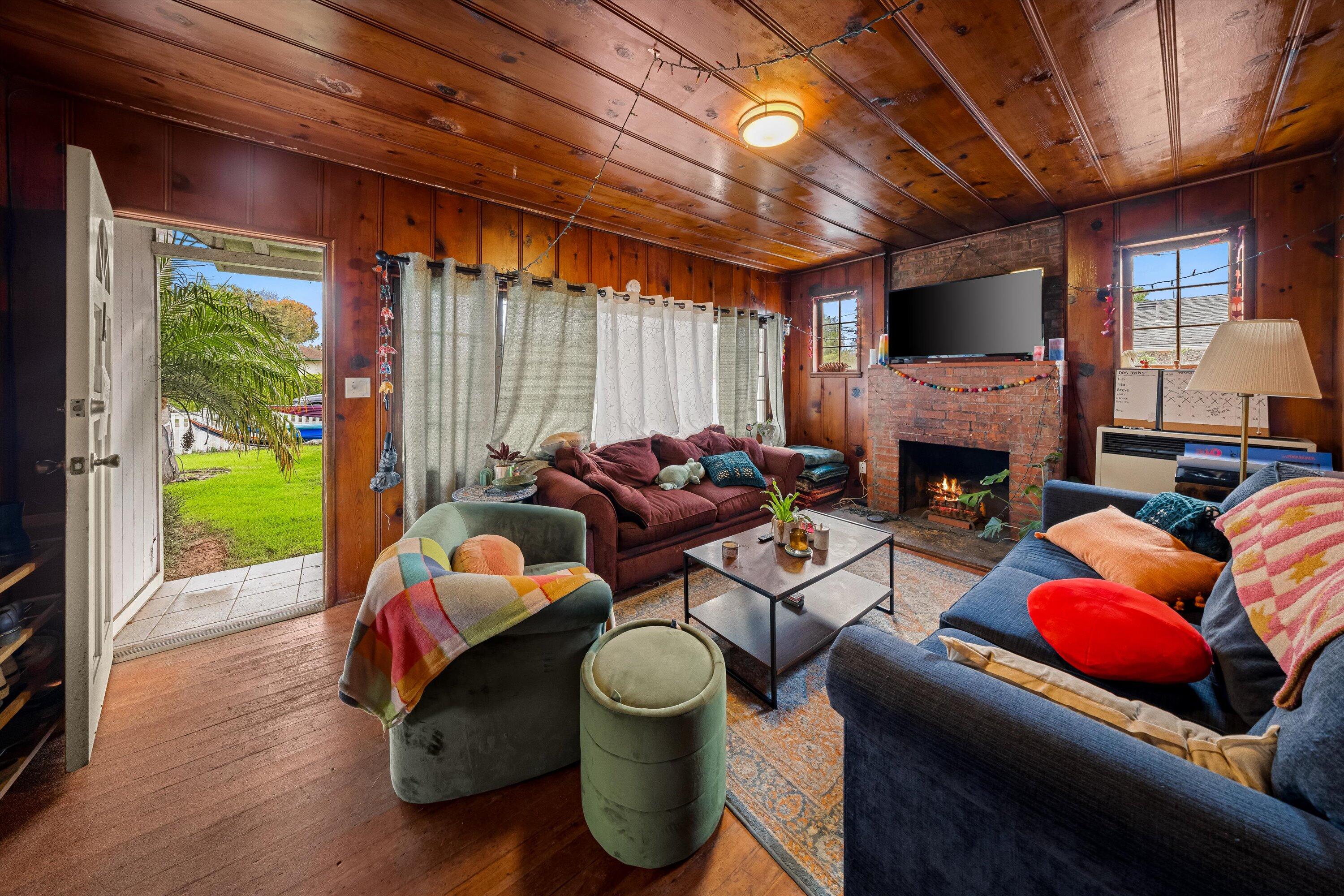 6670 Sueno Road Isla Vista, CA 93117 - Photo 5 of 20 a living room with furniture a fireplace and a flat screen tv