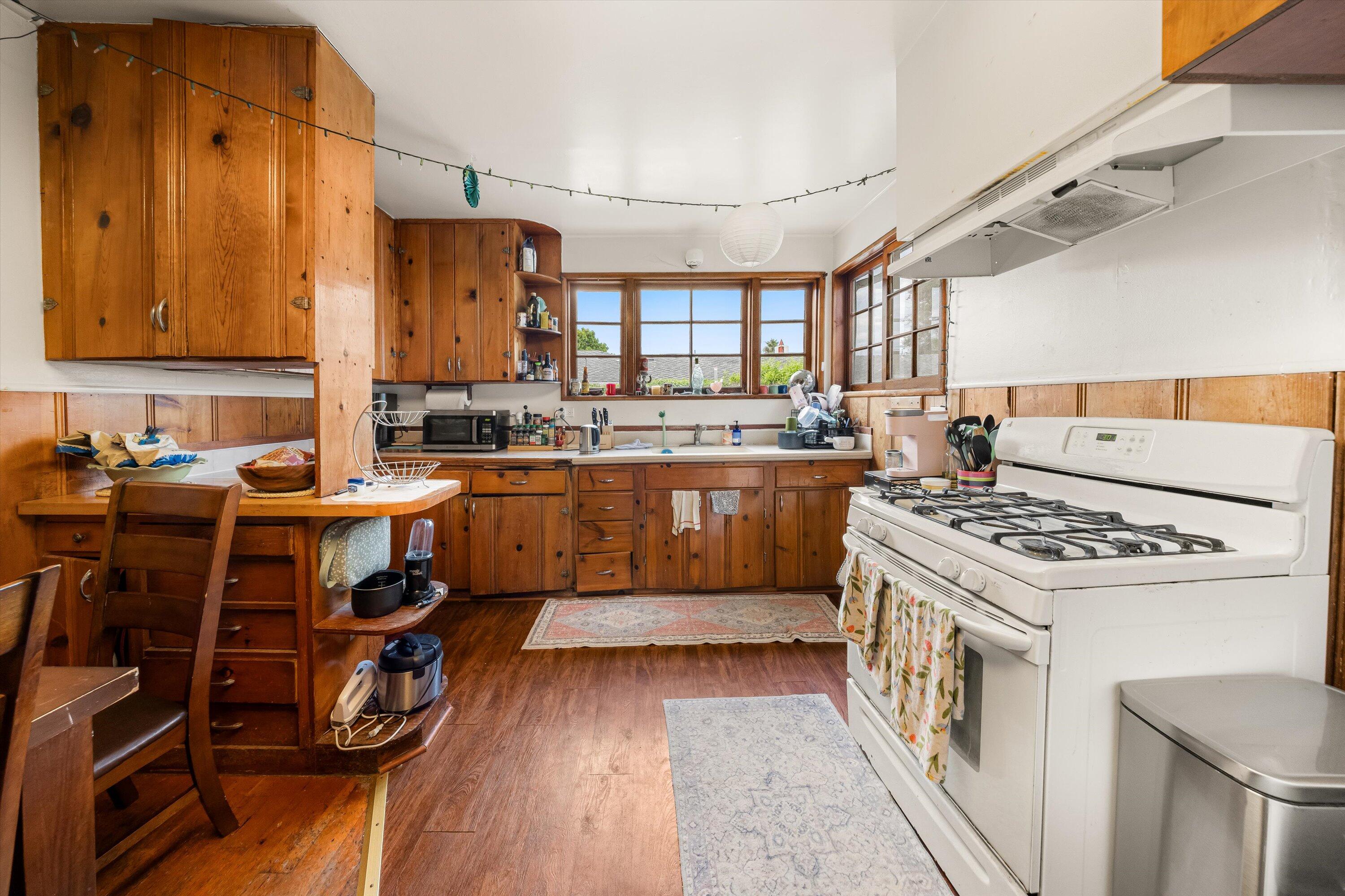 6670 Sueno Road Isla Vista, CA 93117 - Photo 7 of 20 a kitchen with a stove a sink and a refrigerator