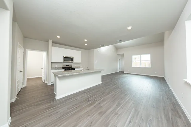 a view of kitchen with closet and wooden floor
