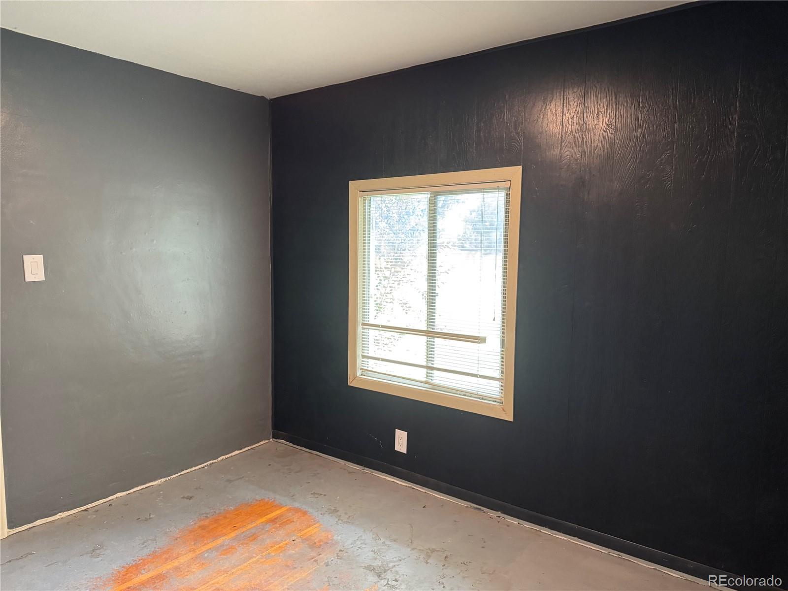 312 Pinon Street Walsenburg, CO 81089 - Photo 3 of 13 a view of an empty room with a window