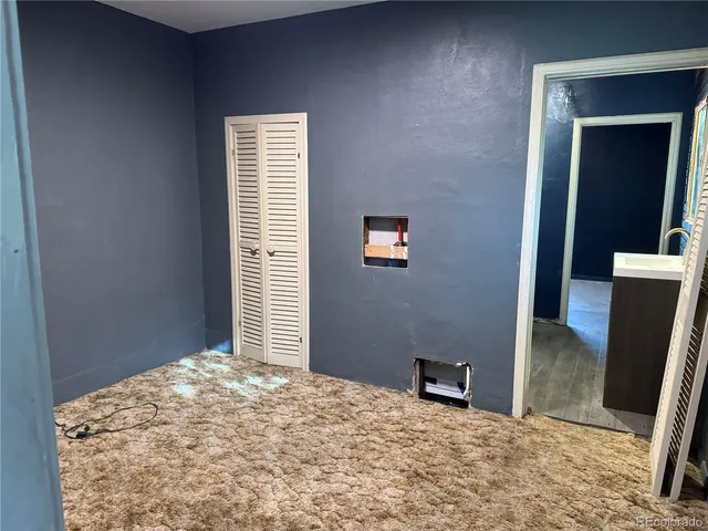 a bedroom with a bed and a mirror