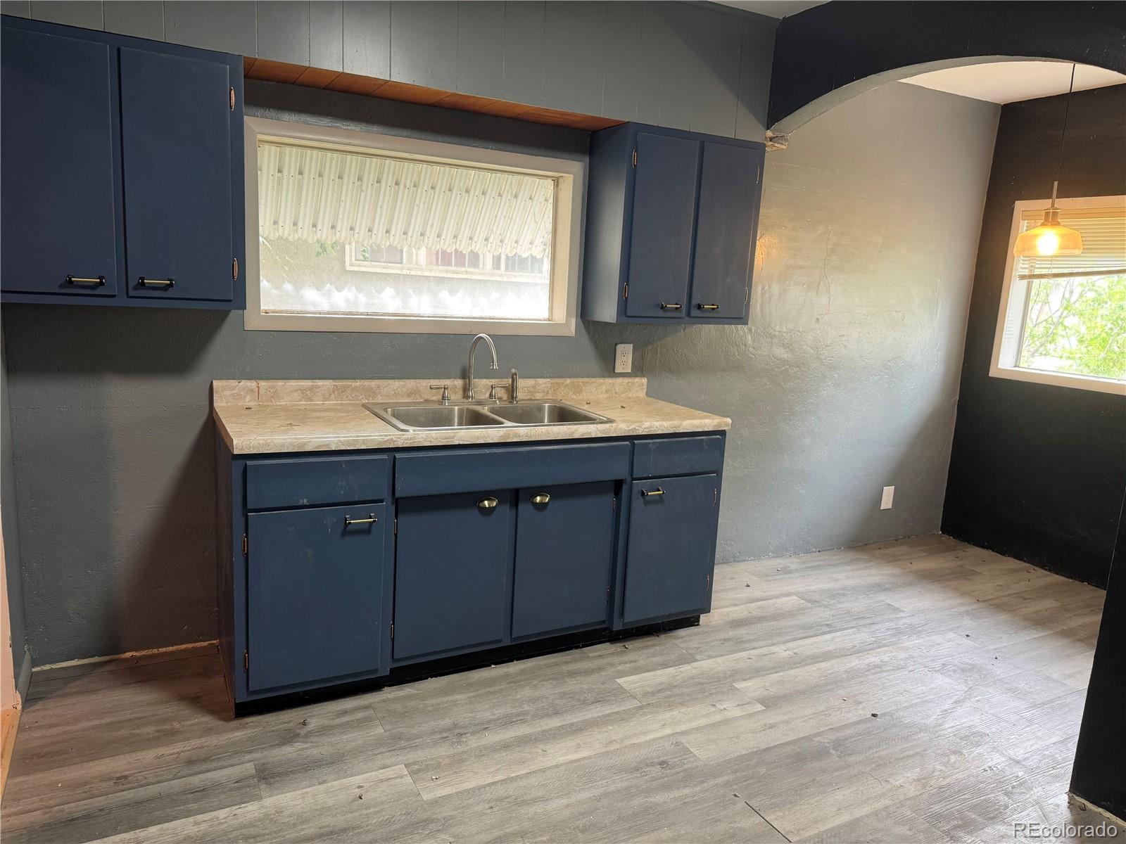 312 Pinon Street Walsenburg, CO 81089 - Photo 7 of 13 a kitchen with a sink cabinets and a window