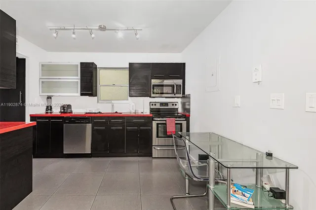 a kitchen with stainless steel appliances granite countertop a stove and a sink