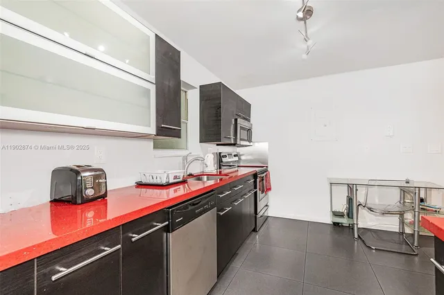 a hallway with a sink and cabinets
