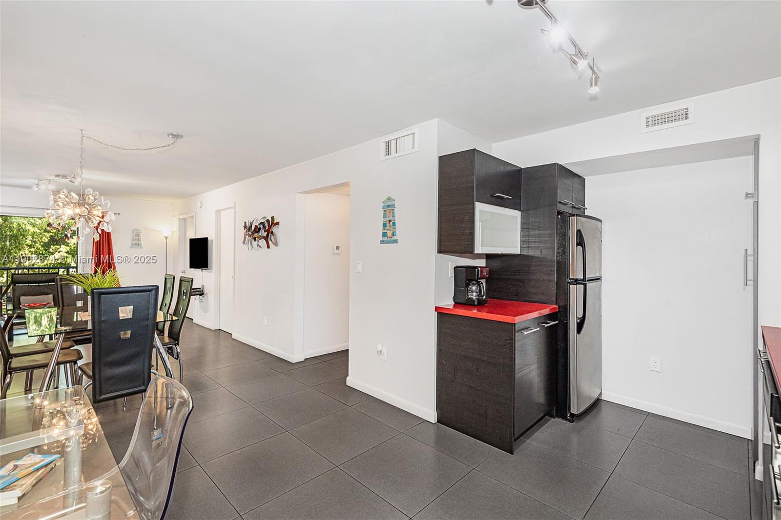 201 178th Drive, Unit 212 Sunny Isles Beach, FL 33160 - Photo 5 of 15 a room with furniture and a refrigerator