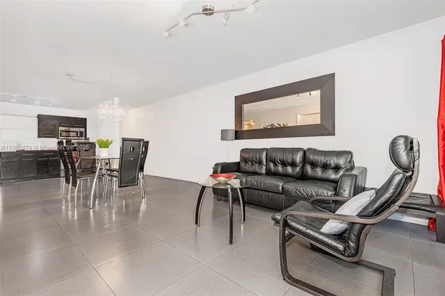 a living room with furniture a wooden floor and a chandelier