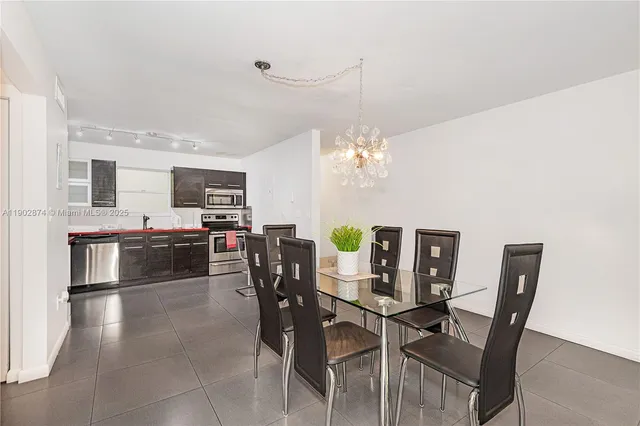 a view of a dining room with furniture and chandelier