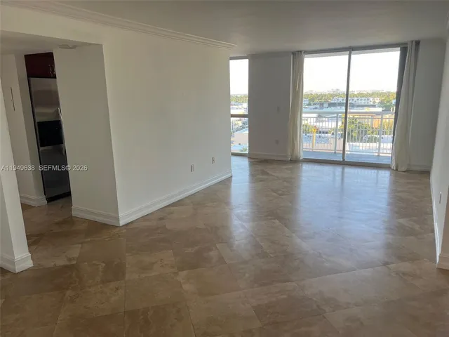 an empty room with large windows