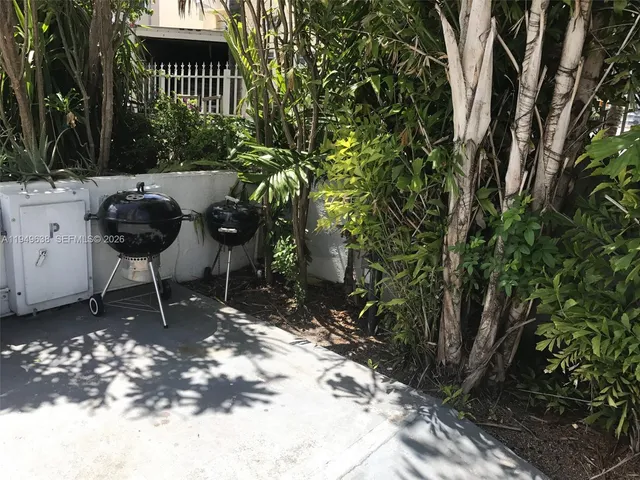 a view of a chairs and table in a backyard