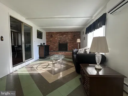 a living room with furniture rug and fireplace