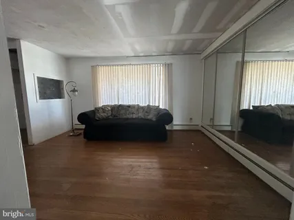 a living room with a bed furniture and a window