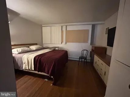 a bedroom with a bed and a table in it
