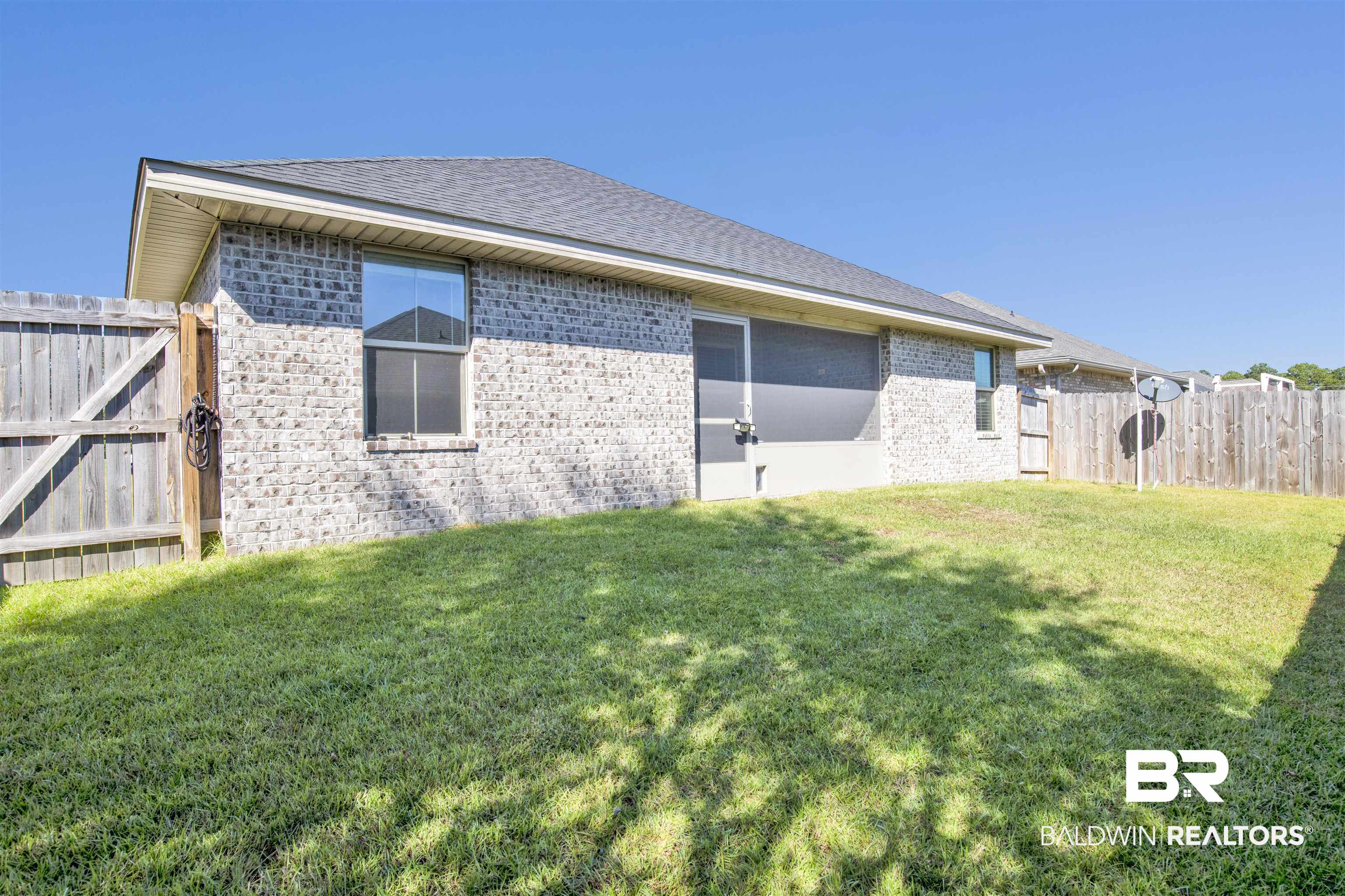 22462 Respite Lane Foley, AL 36535 - Photo 21 of 22 Back of house featuring a yard