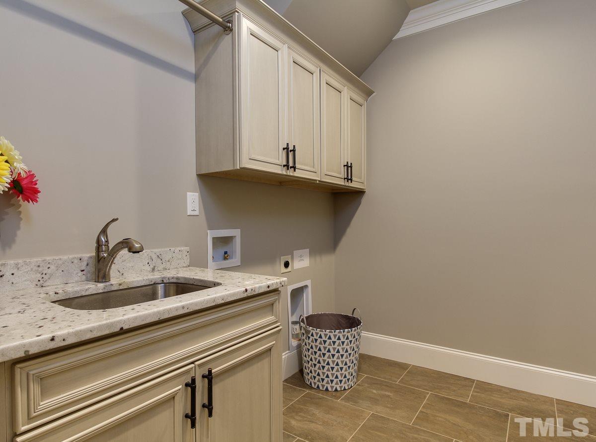 128 Chatterson Drive Raleigh, NC 27615 - Photo 12 of 25 a kitchen with a sink and cabinets