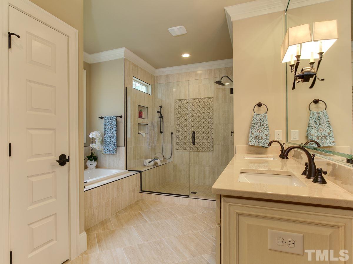 128 Chatterson Drive Raleigh, NC 27615 - Photo 14 of 25 a bathroom with a shower sink and mirror