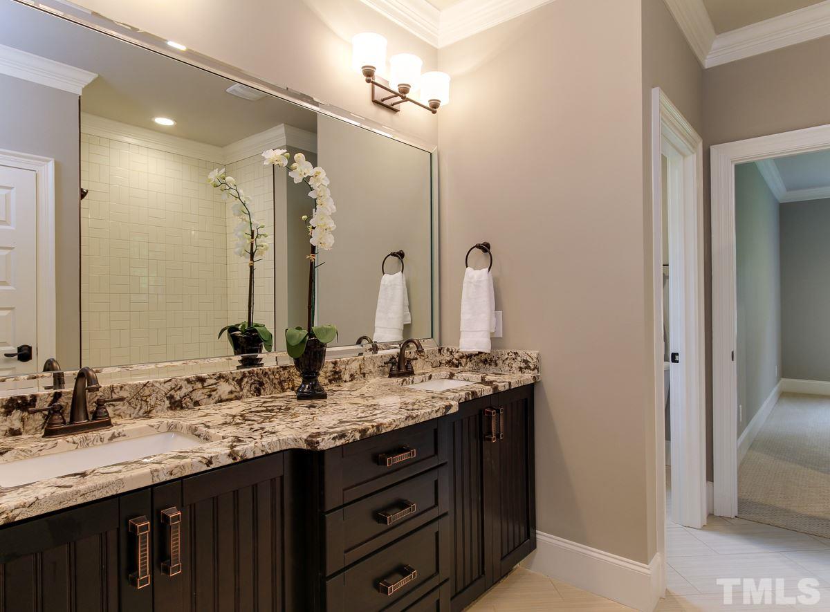 128 Chatterson Drive Raleigh, NC 27615 - Photo 17 of 25 a bathroom with double sink and a mirror