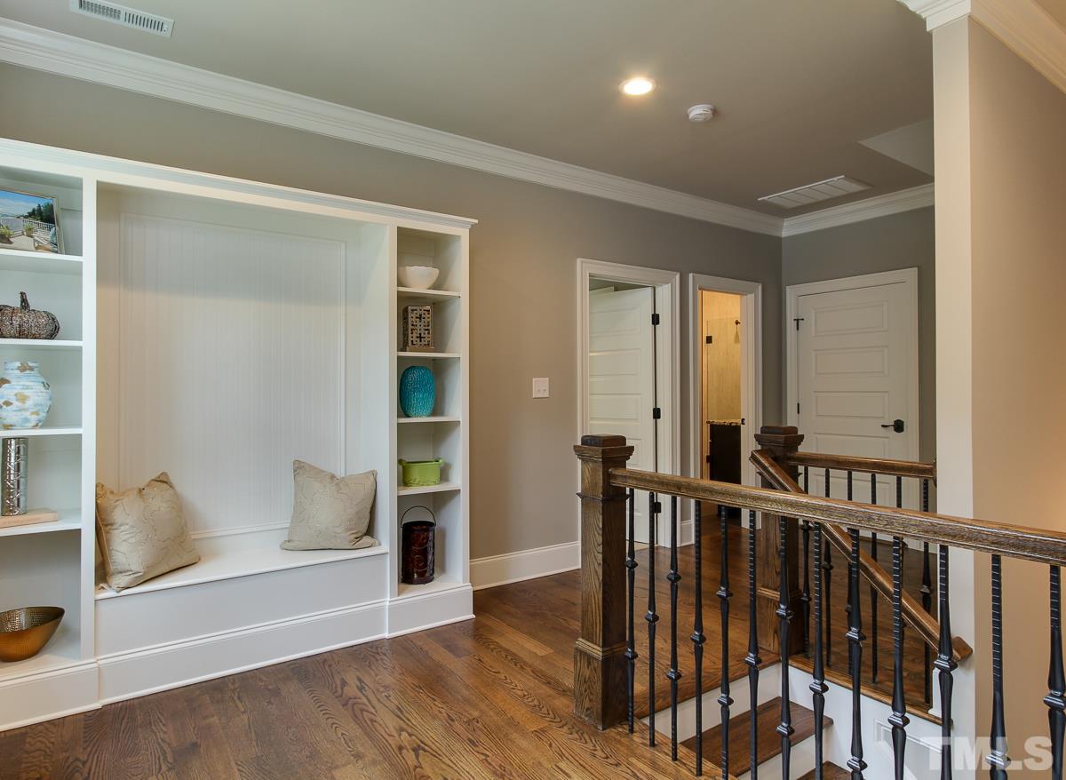 128 Chatterson Drive Raleigh, NC 27615 - Photo 18 of 25 a view of a hallway with wooden floor and windows