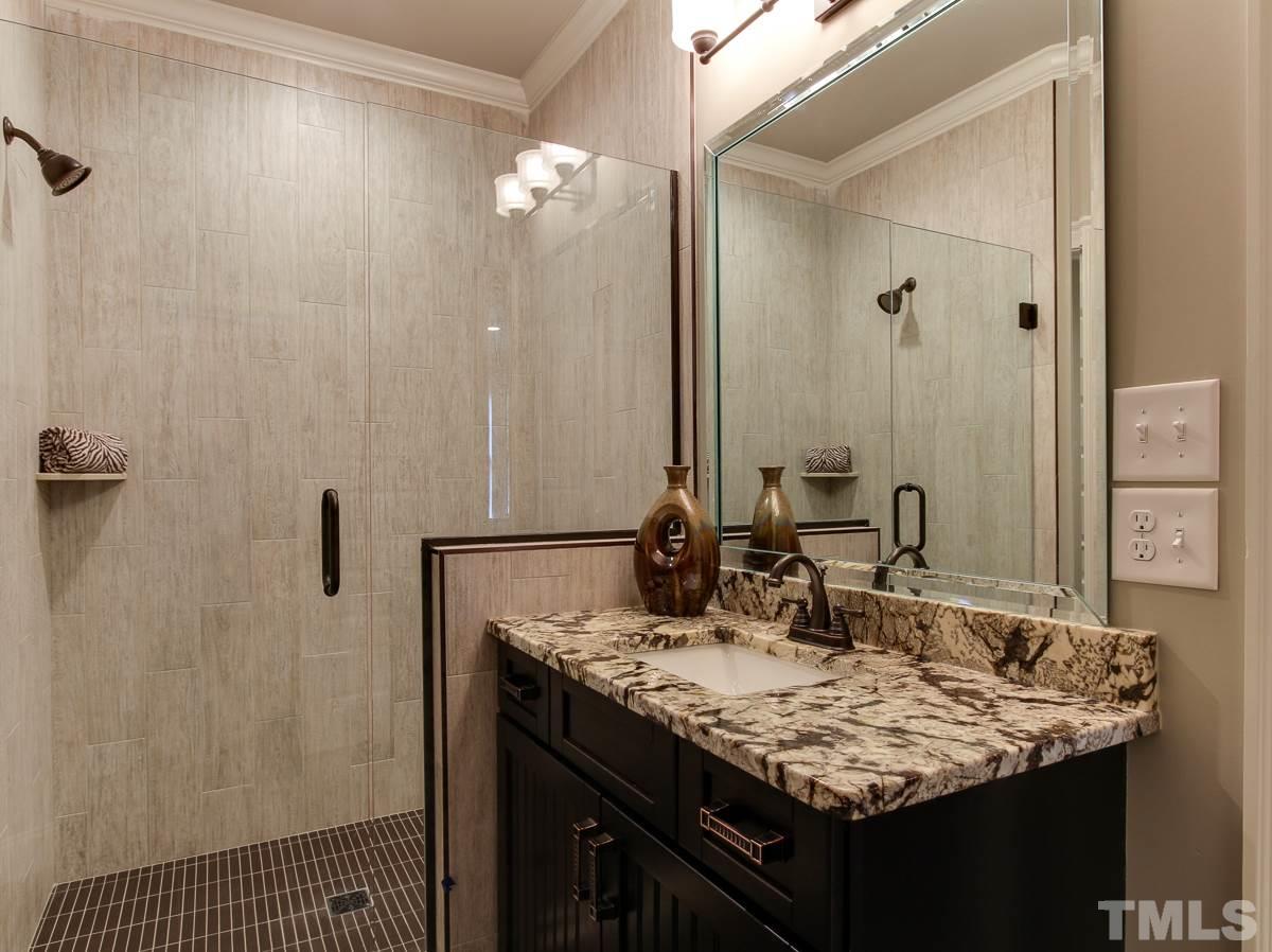 128 Chatterson Drive Raleigh, NC 27615 - Photo 21 of 25 a bathroom with a granite countertop sink and a mirror