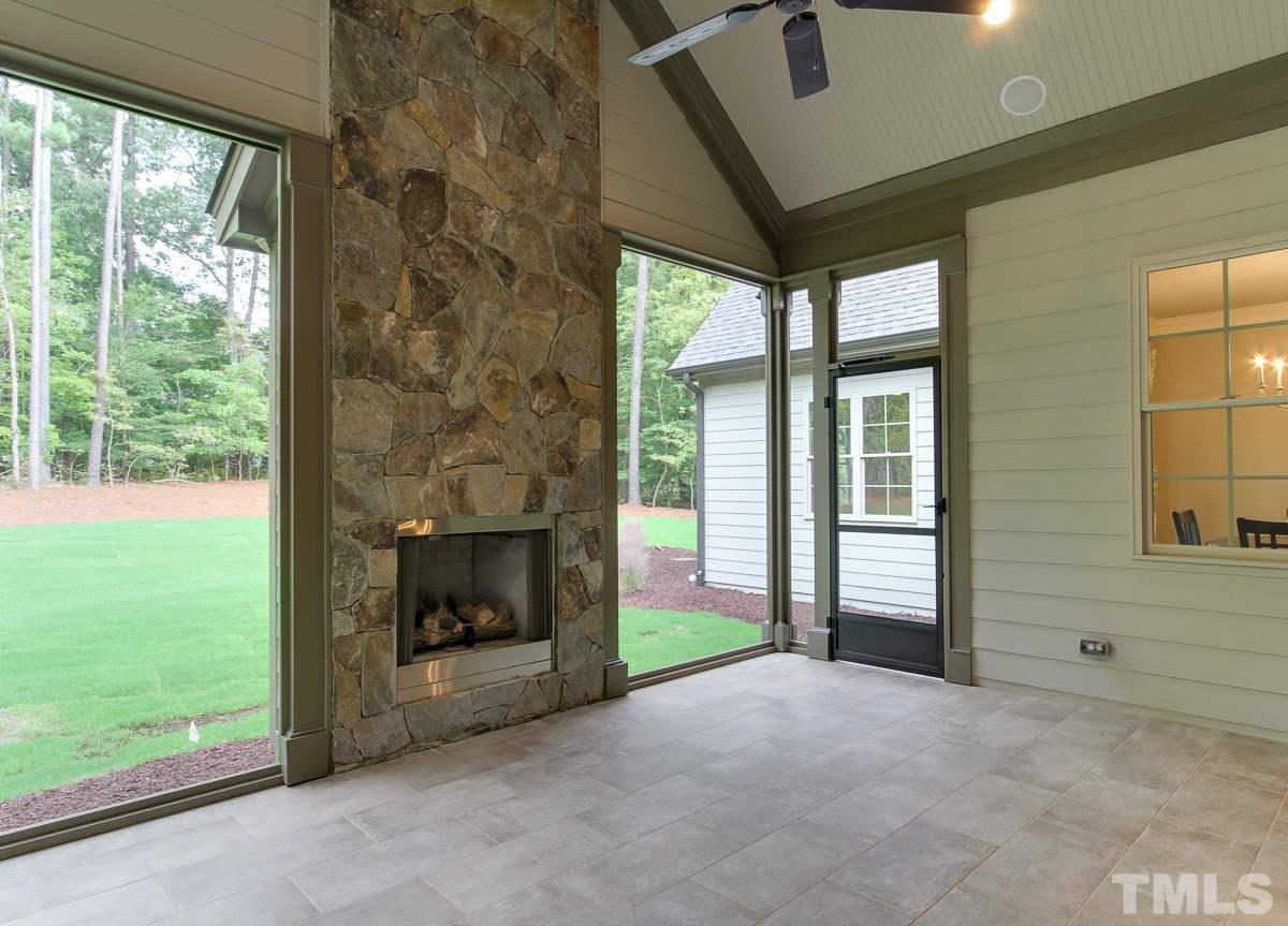128 Chatterson Drive Raleigh, NC 27615 - Photo 23 of 25 a view of an empty room with a fireplace and a window