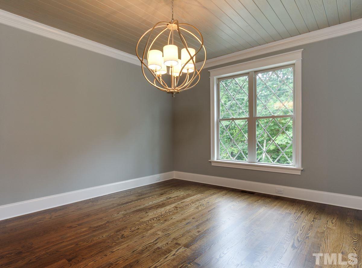 128 Chatterson Drive Raleigh, NC 27615 - Photo 4 of 25 an empty room with wooden floor and windows