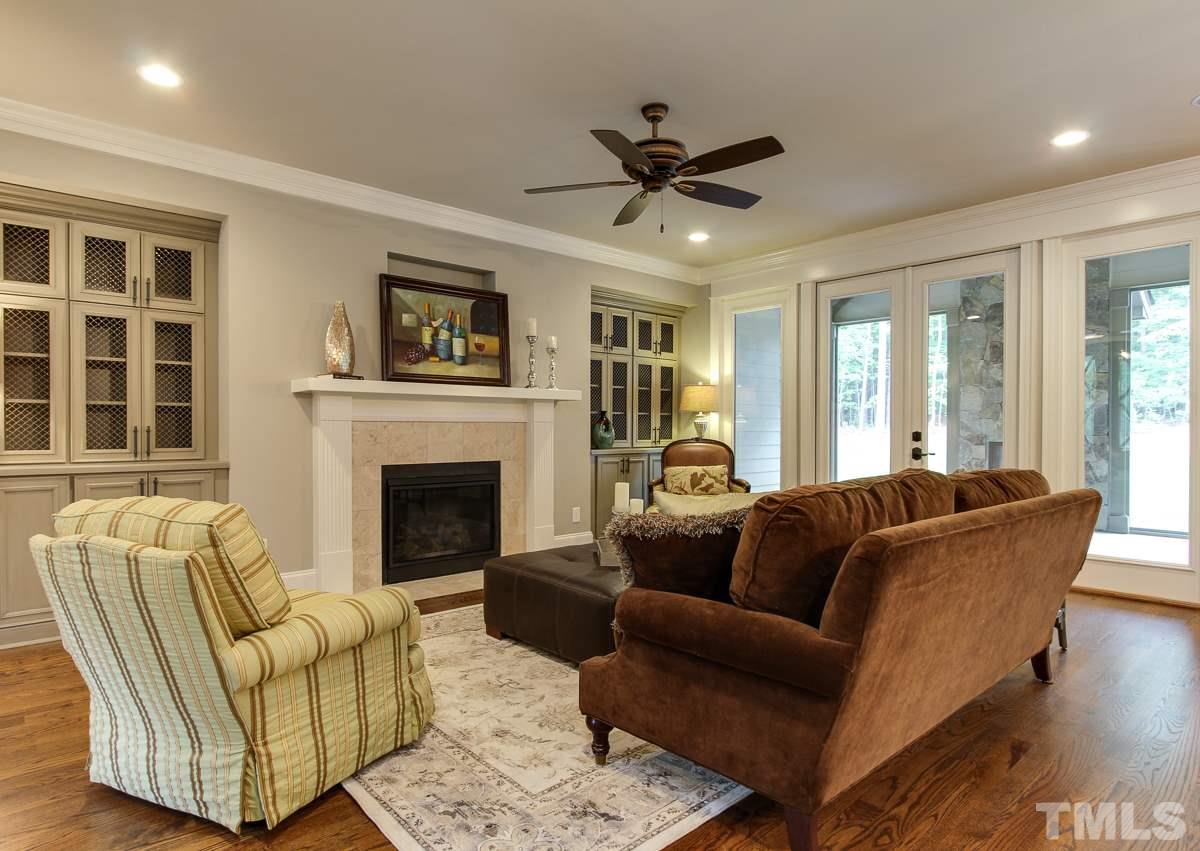 128 Chatterson Drive Raleigh, NC 27615 - Photo 5 of 25 a living room with furniture and a fireplace