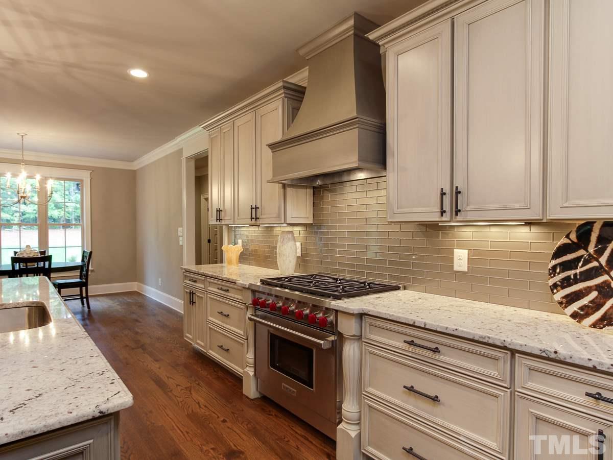 128 Chatterson Drive Raleigh, NC 27615 - Photo 9 of 25 a kitchen with stainless steel appliances granite countertop a stove and a sink