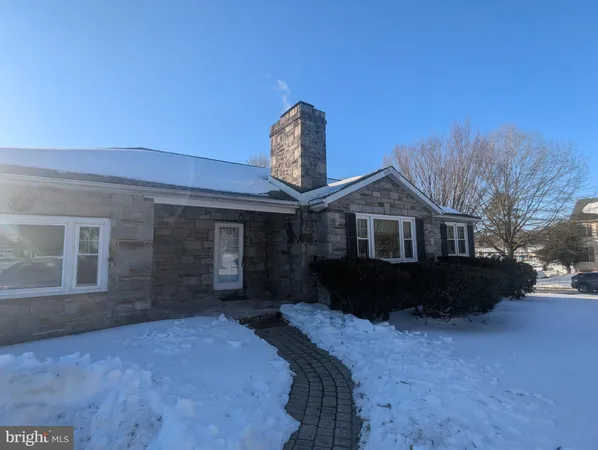 a bath room with a sink and a chair