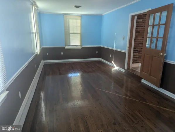 a view of wooden floor and windows in a room