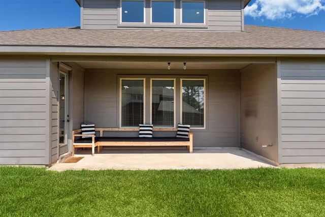 a view of a bench in the backyard